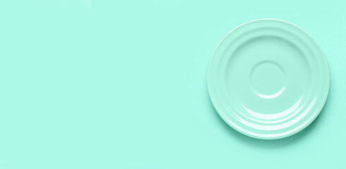 Ceramic plate on mint background with space for text