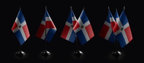 Small national flags of the Dominicana on a black background