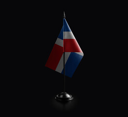 Small national flag of the Dominicana on a black background