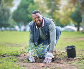 Environment, portrait and black man plant trees in park, garden and nature for sustainability. Community service, soil gardening and smile for volunteering, sustainable growth and happy green ecology © Nicholas F/peopleimages.com