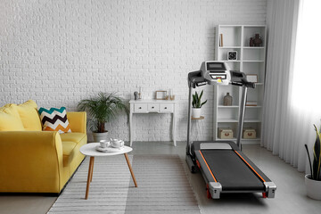 Fototapeta na wymiar Interior of living room with modern treadmill
