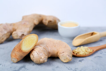 Fresh ginger roots on grunge table, closeup