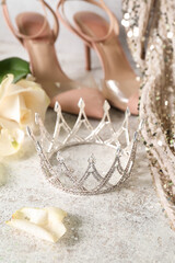 Beautiful tiara with rose petals on grunge table, closeup. Prom concept © Pixel-Shot