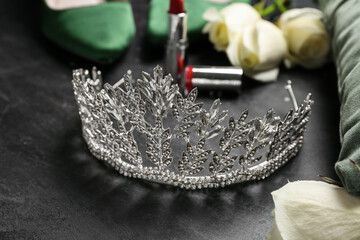 Beautiful tiara on black table, closeup. Prom concept