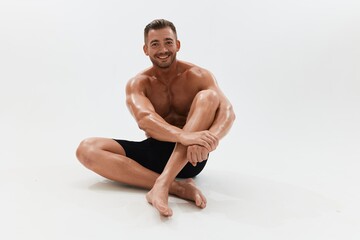 Fototapeta premium Man athletic body bodybuilder in briefs with naked torso abs full-length in the background, fitness classes. Advertising, sports, active lifestyle, competition, challenge concept.