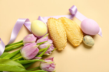 Obraz na płótnie Canvas Tulips with eggs and shekarbura on beige background. Novruz Bayram celebration