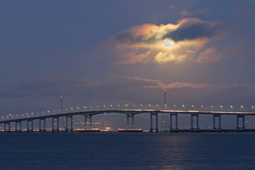 Fototapeta na wymiar Full Moon over the Bridge, San Francisco Bay Area