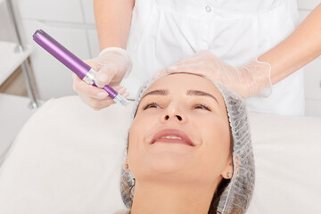 Beautician makes mesotherapy injection for rejuvenation woman face, anti aging non surgical...
