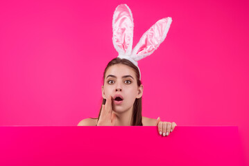 Easter girl. Young woman with bunny ears on studio color background. Easter funny woman with rabbit ears. Portrait of a pretty lovely girl with bunny ears.