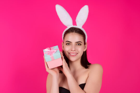 Easter girl. Lovely young woman in rabbit ears celebrating easter holiday, studio background. Holidays party concept. Cheerful girl celebrating Easter in rabbit ears, holding painted eggs.