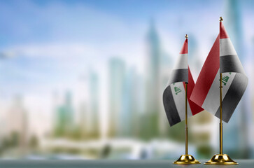 Small flags of the Iraq on an abstract blurry background