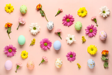 Composition with painted Easter eggs and different flowers on pink background