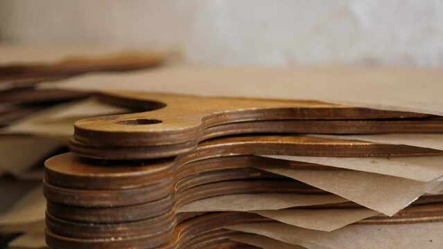 Lots of wooden boards with baking paper for serving pizza in the pizzeria. Traditional Italian pizzeria. Dishes for serving and serving pizza.