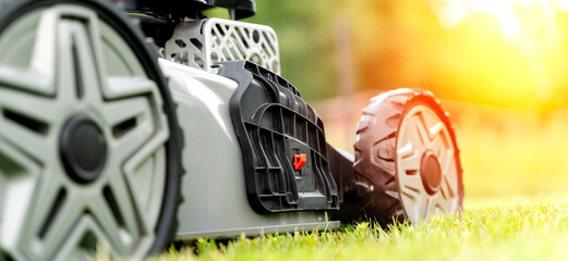 self-propelled lawn mower on a freshly mown lawn on a sunny day