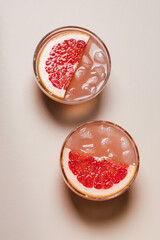 Two glasses of grapefruit cocktail.