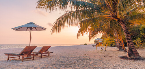 Beautiful panoramic nature. Tropical beach sunset as summer island landscape with chairs umbrella...