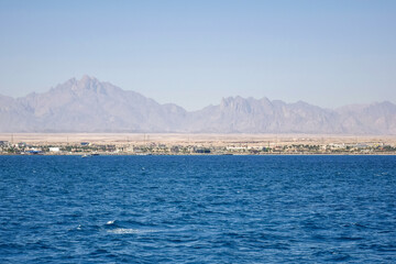Obraz premium Picturesque view of coast from sea. Vacation in Egypt. Copy space. Selective focus.