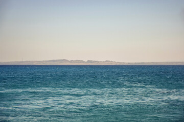 Obraz premium Picturesque view of coast from sea. Vacation in Egypt. Copy space. Selective focus.