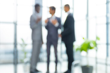 Blurred image of business people standing in the office