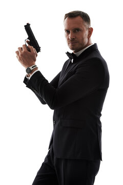 Secret agent man with gun isolated on a white background for law, action movie or security of a criminal businessman. Private detective, professional person crime or actor firearm in studio portrait