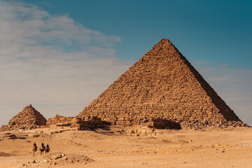 Fototapeta na wymiar Riding Camels Near Pyramids, Giza Egypt