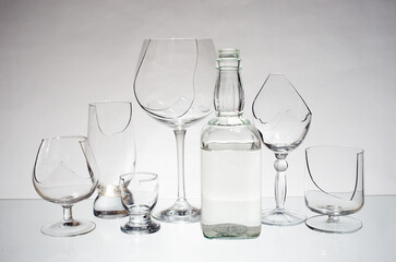 Broken glasses and a bottle of vodka. Stop alcohol.