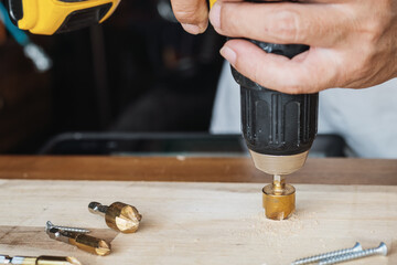 Carpenter use countersink bit to drill both a pilot hole and use countersink bit to recess the head...