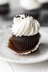 chocolate cake with chocolate muffin cupcake with butter cream and syrup and whipped cream
