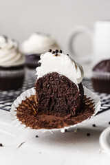 chocolate cake with chocolate muffin cupcake with butter cream and syrup and whipped cream