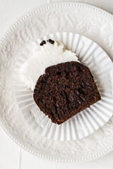 chocolate cake with chocolate muffin cupcake with butter cream and syrup and whipped cream