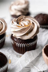 chocolate cake with chocolate muffin cupcake with butter cream and syrup and whipped cream