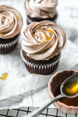 chocolate cake with chocolate muffin cupcake with butter cream and syrup and whipped cream