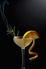 Limoncello garnished with a steaming rosemary branch.