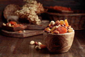 Dried fruits and assorted nuts on a wooden table.