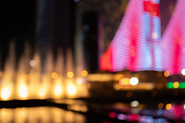 night city, dancing fountains, cityscape, blurred background