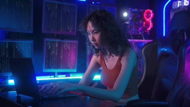 A Hacker is using laptop computer to steal data in the night