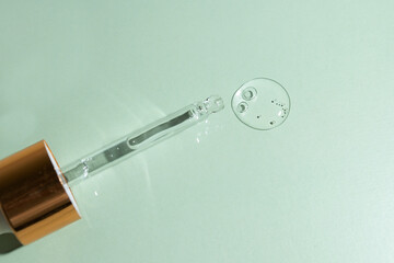 moisturizing serum with hyaluronic acid, facial oil on a green natural background
