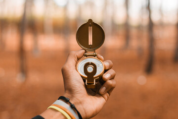 Traveler holding compass in hand, Blurred background