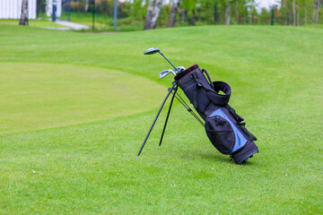The Golf club bag for golfer training and play in game with golf course background , green tree...