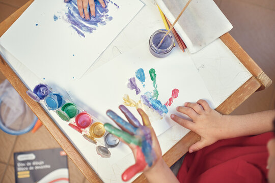 children playing in an inner courtyard and painting with water paints