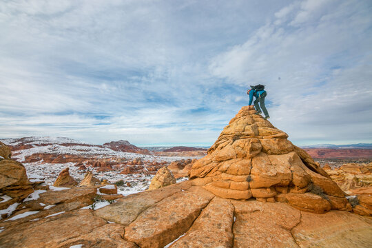 Hiker scales butte in Cottonwood Cove, South Coyote Buttes