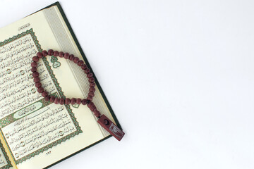 Kitab Al - Qur'an, Muslim prayer, and tasbih on white background