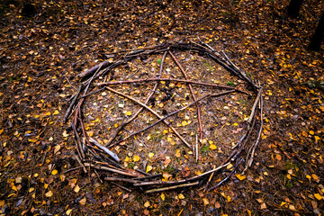 Pentagram or a symbol of Satan and Baphomet made of twigs was seen as a symbol in autumn.