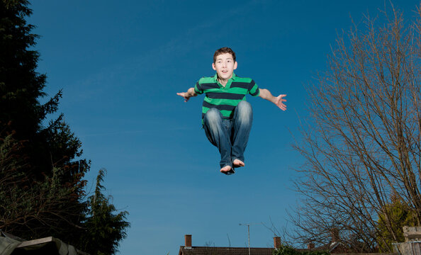 boy jumping on trampoline in Woking - England