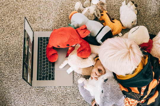 Young boy video conferencing with class on computer
