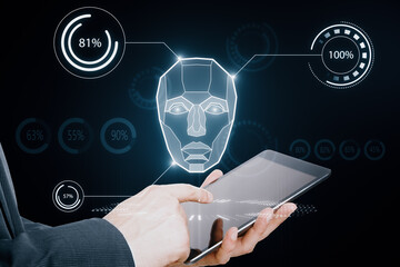 AI system in hologram human head with HUD display elements. Artificial Intelligence for VR with tech shapes HUD. Biometric technology, face recognition systems. Male hand pointing at cellphone.