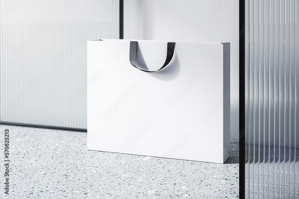 Aufkleber perspective view on blank white paper shopping bag with place for your brand name or text on light c
