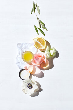 Still life of skin care products, fresh lemon, flower pedals