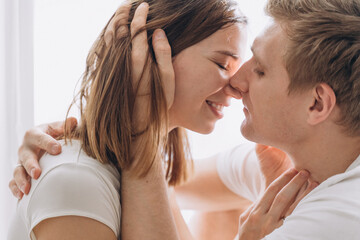Close-up of a couple of lovers kissing on a white background