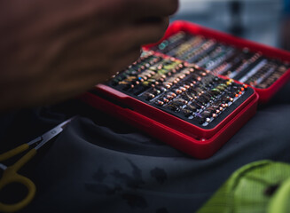 A close-up photo of a box of artificial flies used for fly fishing